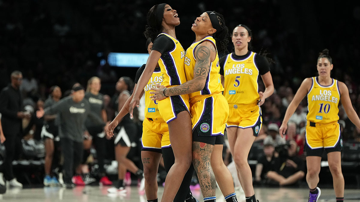 Los Angeles Sparks forwards Emma Cannon (32) and Rickea Jackson (2) celebrate after scoring against the Las Vegas Aces during the first half of a WNBA basketball game at Michelob Ultra Arena.