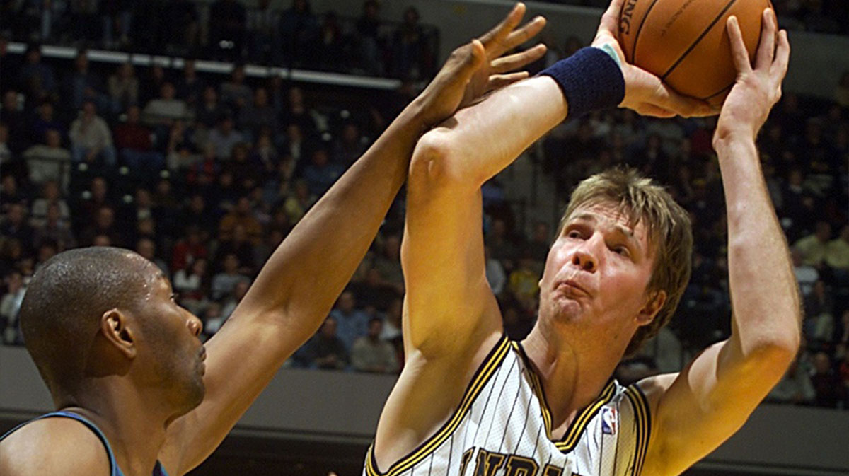 Pacer Rik Smits puts a shot against the defense of Charlotte's Elden Campbell during the first half of their game Thursday night at the Conseco Fieldhouse