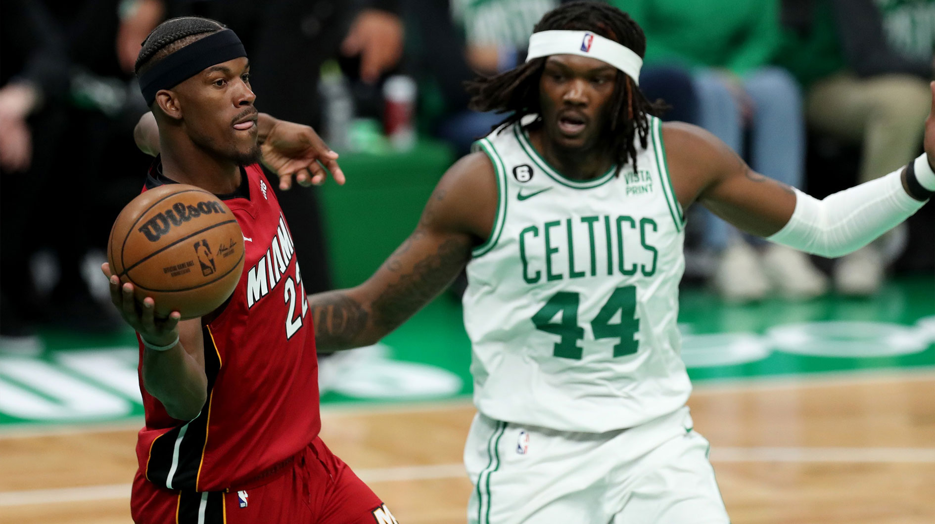 Miami Heat forward Jimmy Butler (22) passes against Boston Celtics center Robert Williams III (44) during the second half in game one of the Eastern Conference Finals for the 2023 NBA playoffs at TD Garden.