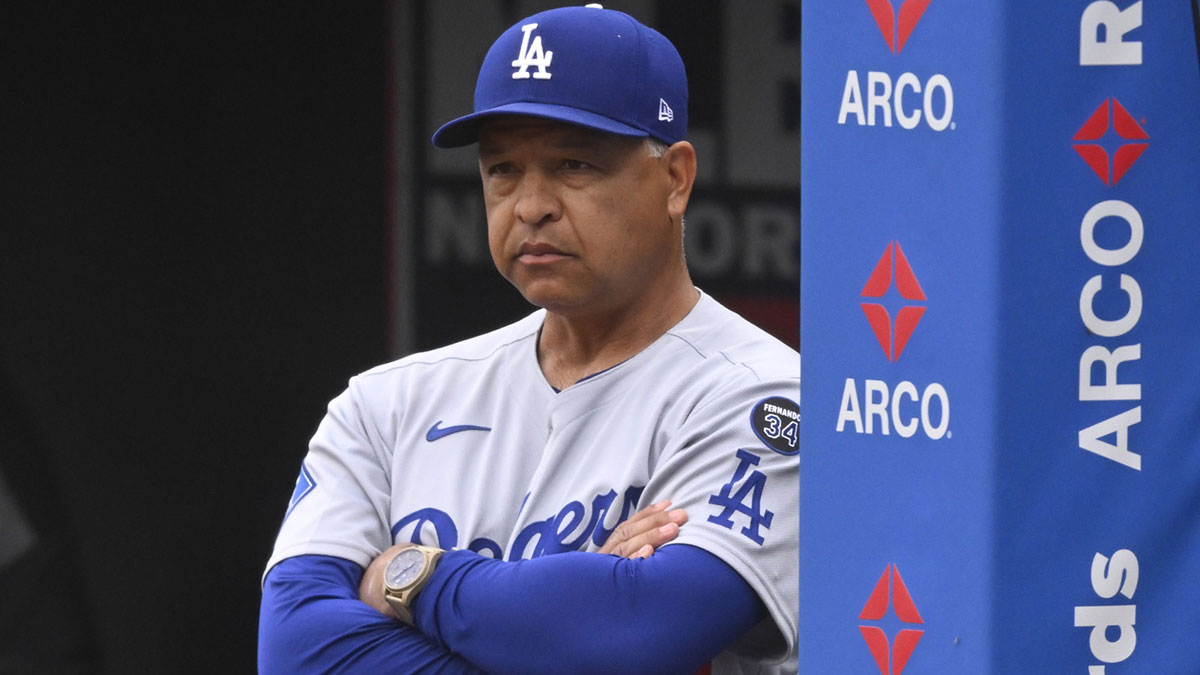 Los Angeles Dodgers manager Dave Roberts (30) stands in the dugout in the third inning against the Cleveland Guardians at Progressive Field.