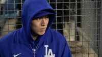 Los Angeles Dodgers pitcher Roki Sasaki (11) looks on in the dougout during the third inning of the game against the Athletics at Dodger Stadium.