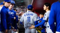 May 9, 2025; Phoenix, Arizona, USA; Los Angeles Dodgers pitcher Roki Sasaki (11) is greeted by Shohei Ohtani as he leaves the game in the fifth inning against the Arizona Diamondbacks at Chase Field. Mandatory Credit: Mark J. Rebilas-Imagn Images