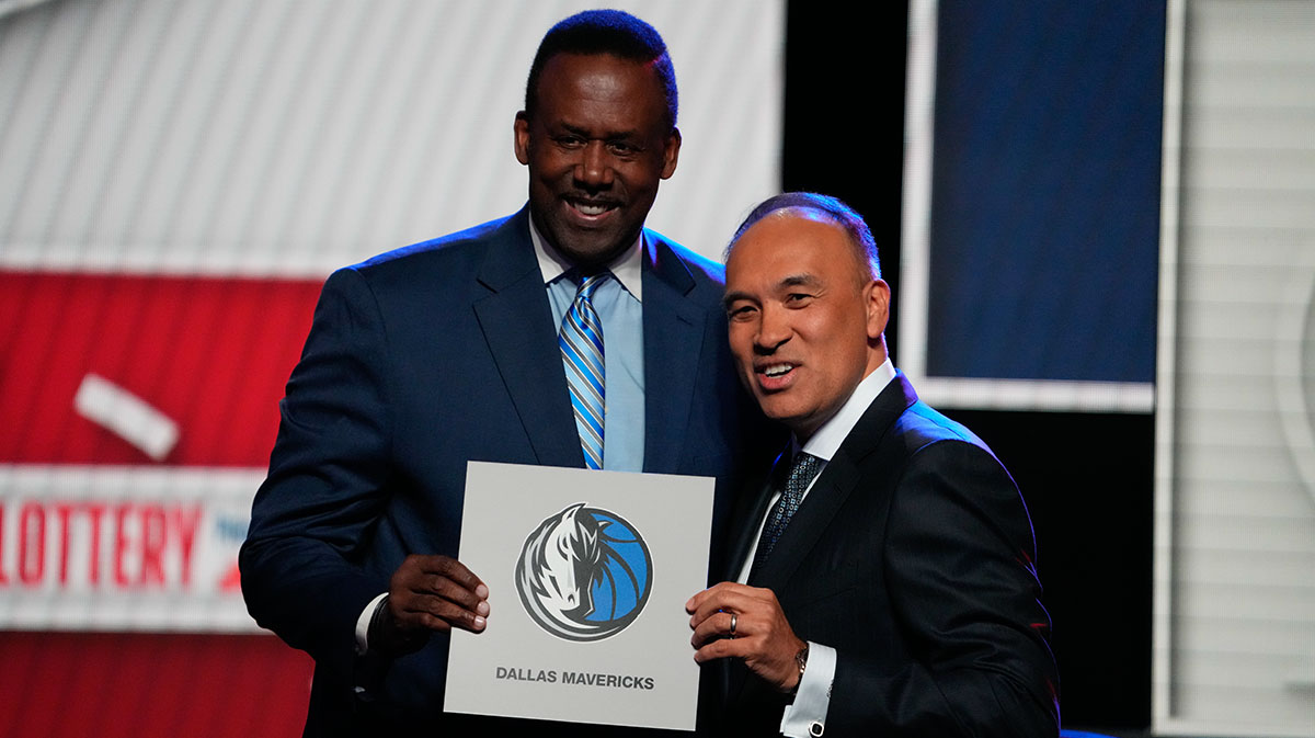 Rolando Blackman of the Dallas Mavericks poses with Mark Tatum NBA Deputy Commissioner after winning the the first pick during the 2025 NBA Draft Lottery at McCormick Place.