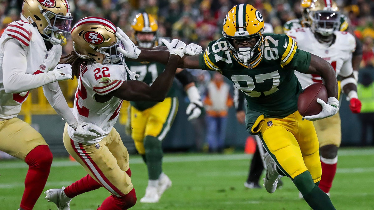 Green Bay Packers wide receiver Romeo Doubs (87) stiff-arms San Francisco 49ers cornerback Isaac Yiadom (22) as he runs after making a catch on Sunday, November 24, 2024, at Lambeau Field in Green Bay, Wis. The Packers won the game, 38-10.