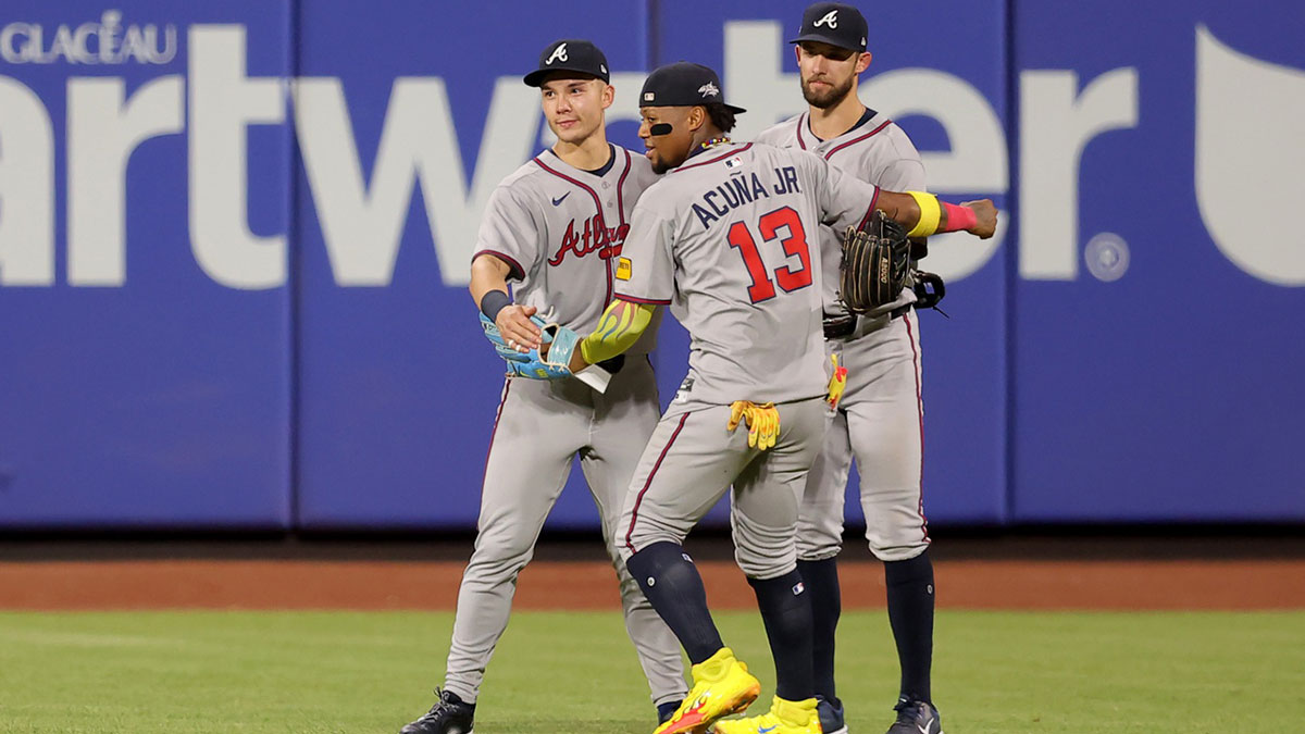 Atlanta Braves left fielder Stuart Fairchild (17) and right fielder Ronald Acuna Jr. (13) and center fielder Eli White (36) celebrate after defeating the New York Mets at Citi Field.