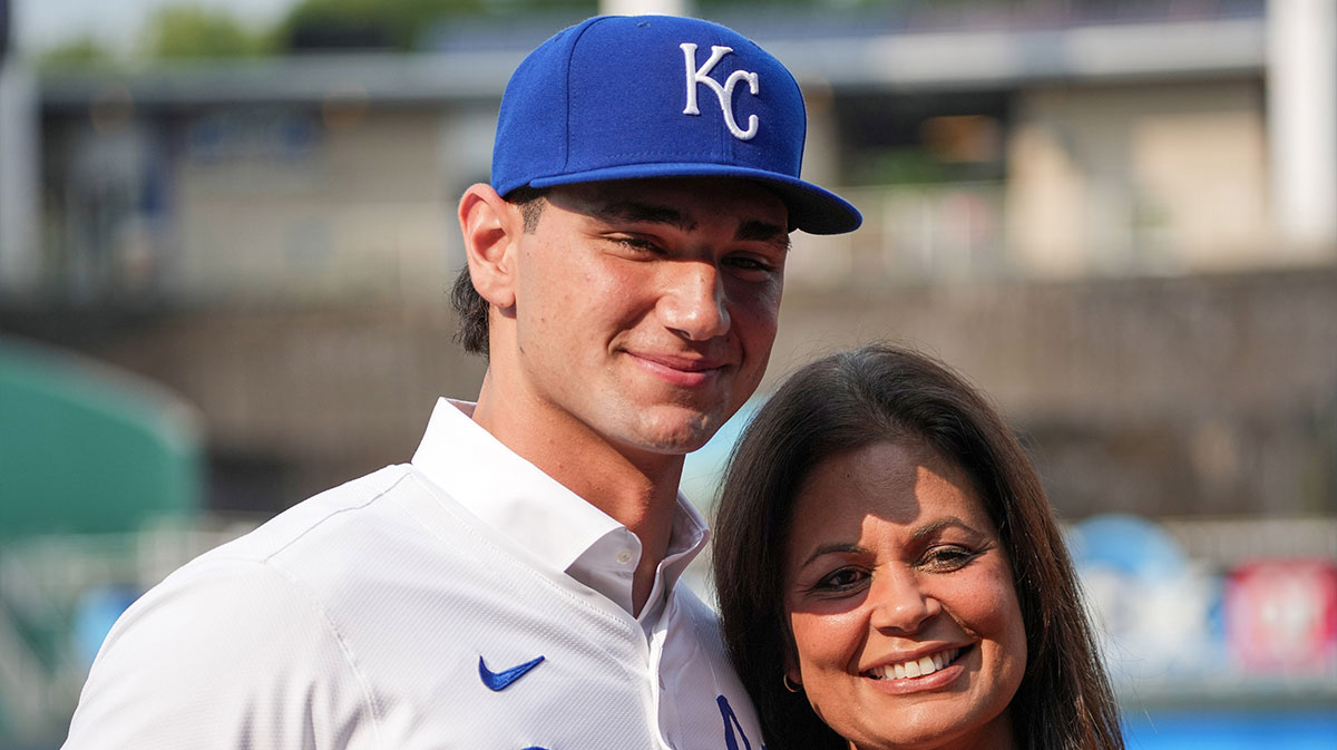 Kansas City Royals first round draft pick Jac Caglianone poses with his mother Johanne Caglianone for photos on the field prior to a game against the Arizona Diamondbacks at Kauffman Stadium.