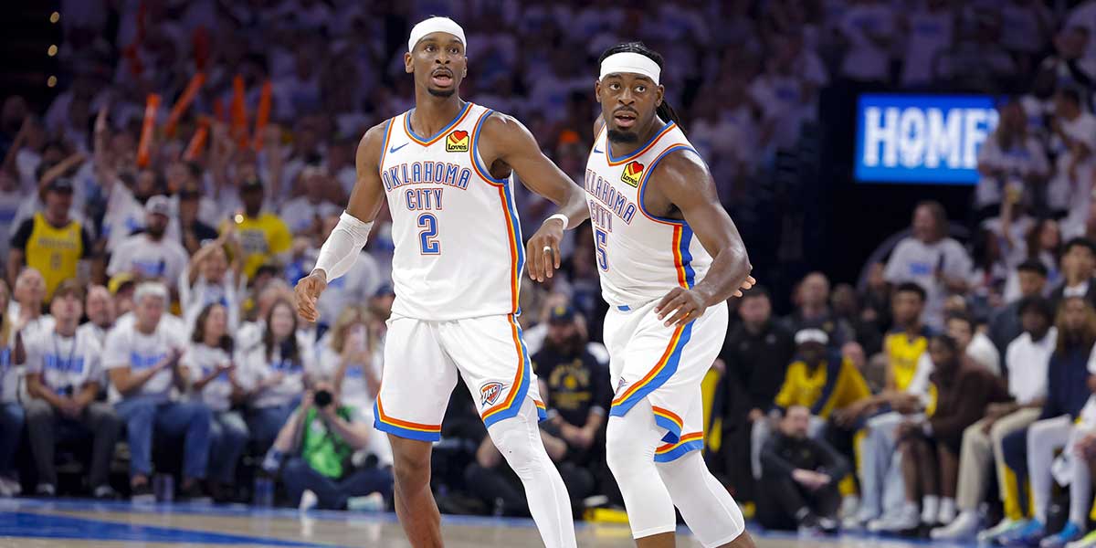 Oklahoma City Thunder guard Shai Gilgeous-Alexander (2) and guard Luguentz Dort (5) look on during the third quarter against the Indiana Pacers during game one of the 2025 NBA Finals at Paycom Center.
