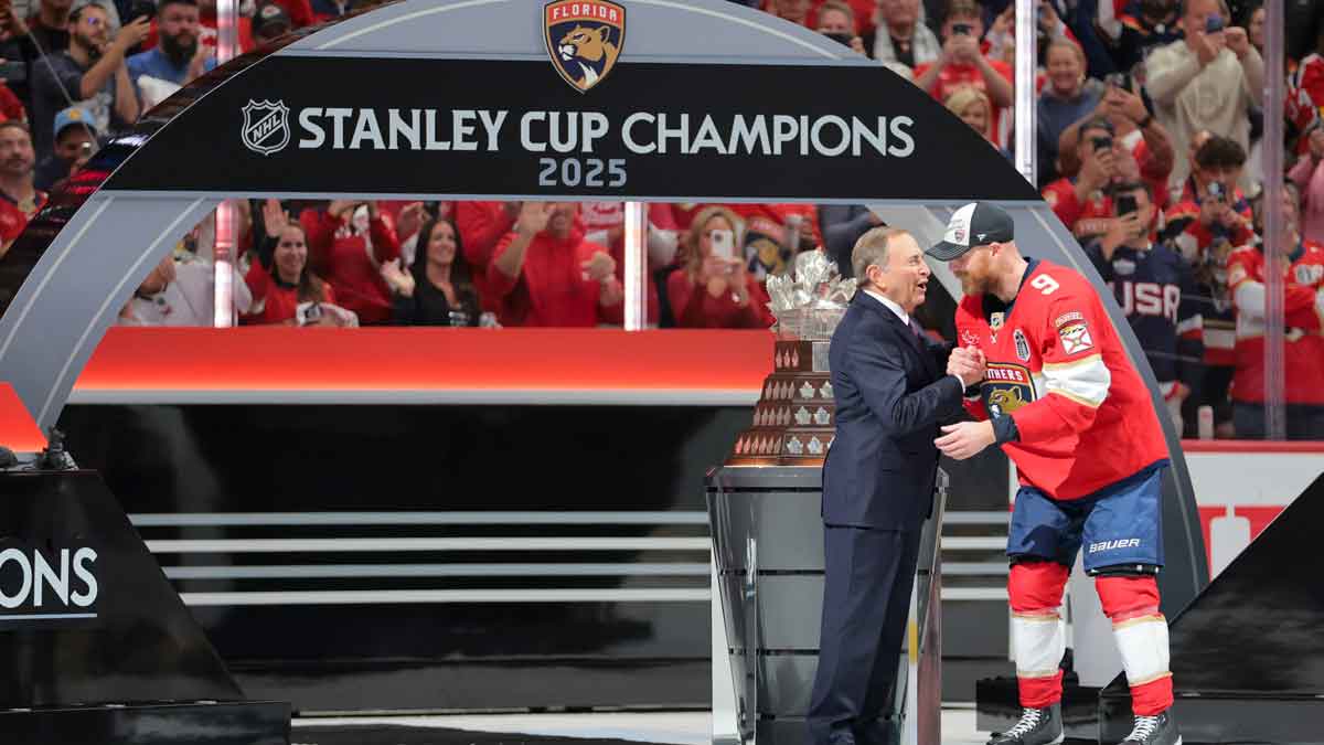 Gary Bettman, NHL Commissioner, presents Florida Panthers center Sam Bennett (9) the Conn Smythe Trophy after winning game six of the 2025 Stanley Cup Final against the Edmonton Oilers at Amerant Bank Arena.
