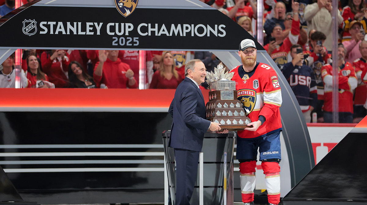 Gary Bettman, NHL Commissioner, presents Florida Panthers center Sam Bennett (9) the Conn Smythe Trophy after winning game six of the 2025 Stanley Cup Final against the Edmonton Oilers at Amerant Bank Arena.