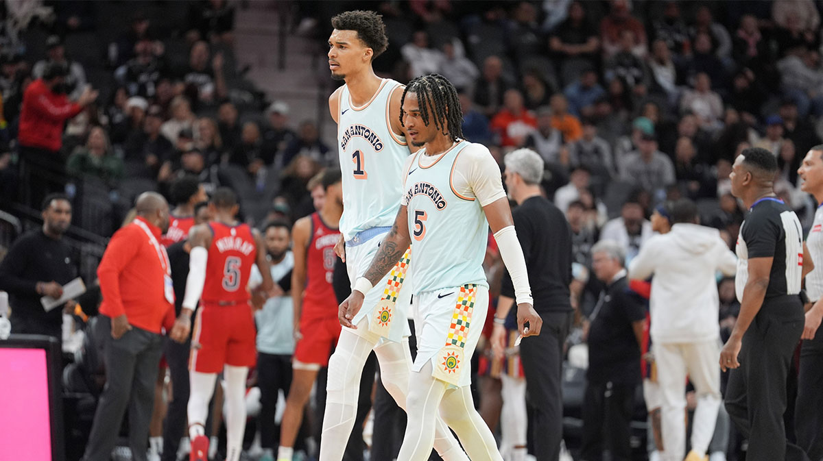 San Antonio Spurs center Victor Wembanyama (1) and guard Stephon Castle (5) walk toward the bench in the second half against the New Orleans Pelicans at Frost Bank Center.