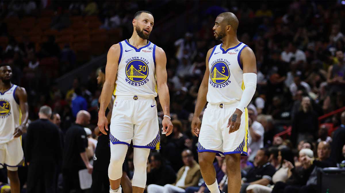 Golden State Warriors guard Stephen Curry (30) and guard Chris Paul (3) talk during the fourth quarter agains the Miami Heat at Kaseya Center.