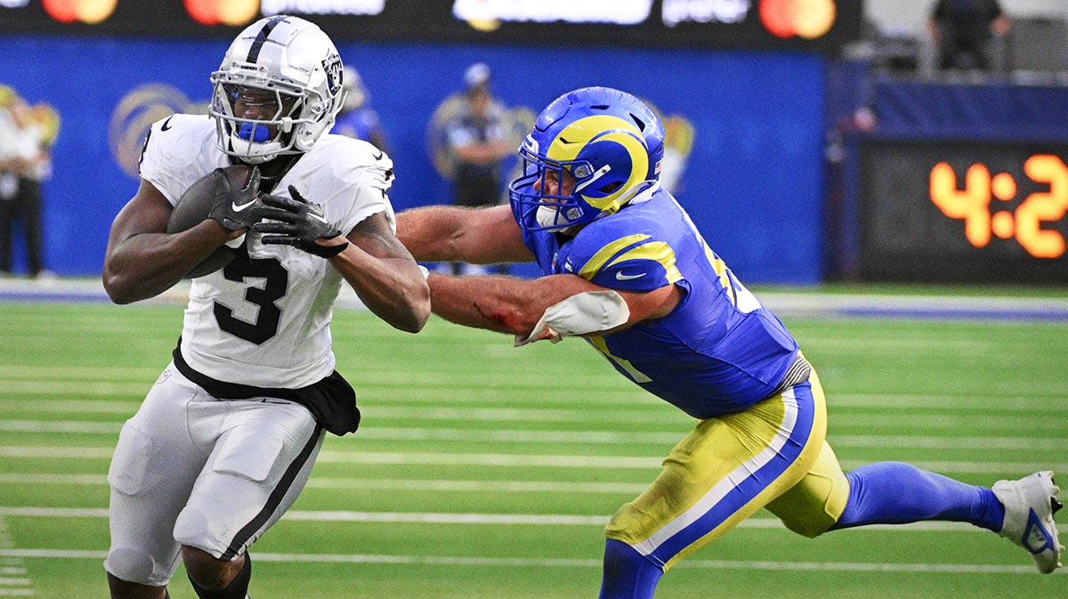 Los Angeles Rams linebacker Troy Reeder (51) pushes Las Vegas Raiders running back Zamir White (3) out-of-bounds in the second half at SoFi Stadium.