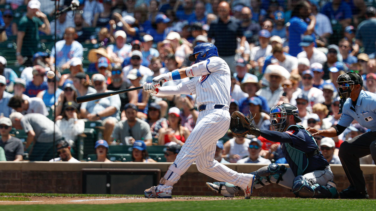 Chicago Cubs right fielder Seiya Suzuki (27) hits a solo home run against the Seattle Mariners during the first inning at Wrigley Field.