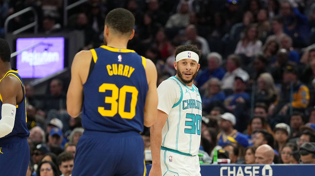 Charlotte Hornets guard Seth Curry (right) talks with Golden State Warriors guard Stephen Curry (left) during the fourth quarter at Chase Center.