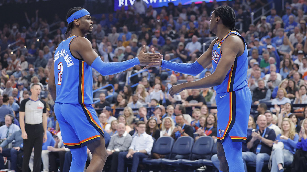 Oklahoma City Thunder guard Shai Gilgeous-Alexander (2) and forward Jalen Williams (8) high five after a play against the Detroit Pistons during the first quarter at Paycom Center.