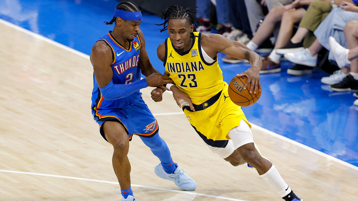 Indiana Pacers forward Aaron Nesmith (23) moves the ball past Oklahoma City Thunder guard Shai Gilgeous-Alexander (2) during the third quarter of game two of the 2025 NBA Finals at Paycom Center.