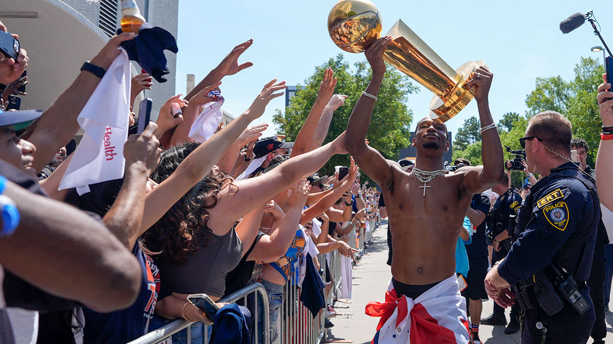 Oklahoma City Thunder guard Shai Gilgeous-Alexander carries the Larry O'Brien trophy as he celebrates with fans as the Oklahoma City Thunder celebrate their first NBA Finals title win with a champions parade throughout downtown Oklahoma City on Tuesday, June 24, 2025.