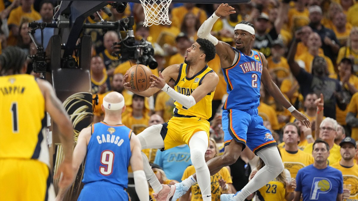 Indiana Pacers guard Tyrese Haliburton (0) drives to the hoop past Oklahoma City Thunder guard Shai Gilgeous-Alexander (2) during the second quarter of game four of the 2025 NBA Finals at Gainbridge Fieldhouse.