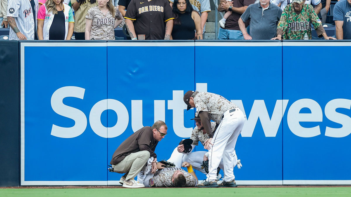 San Diego Padres manager Mike Shildt (8) and training staff attend to San Diego Padres left fielder Gavin Sheets (30) during the fourth inning against the Pittsburgh Pirates at Petco Park.