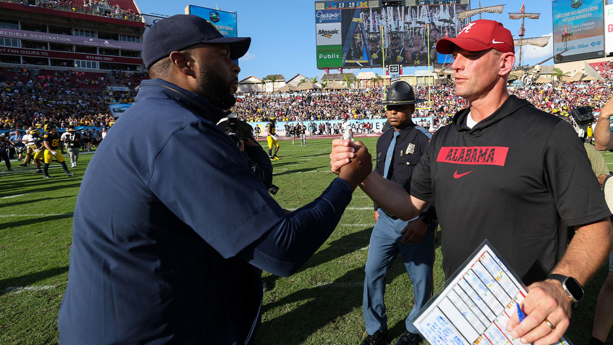 Michigan Wolverines head coach Sherrone Moore greets Alabama Crimson Tide head coach Kalen Deboer after the ReliaQuest Bowl at Raymond James Stadium.