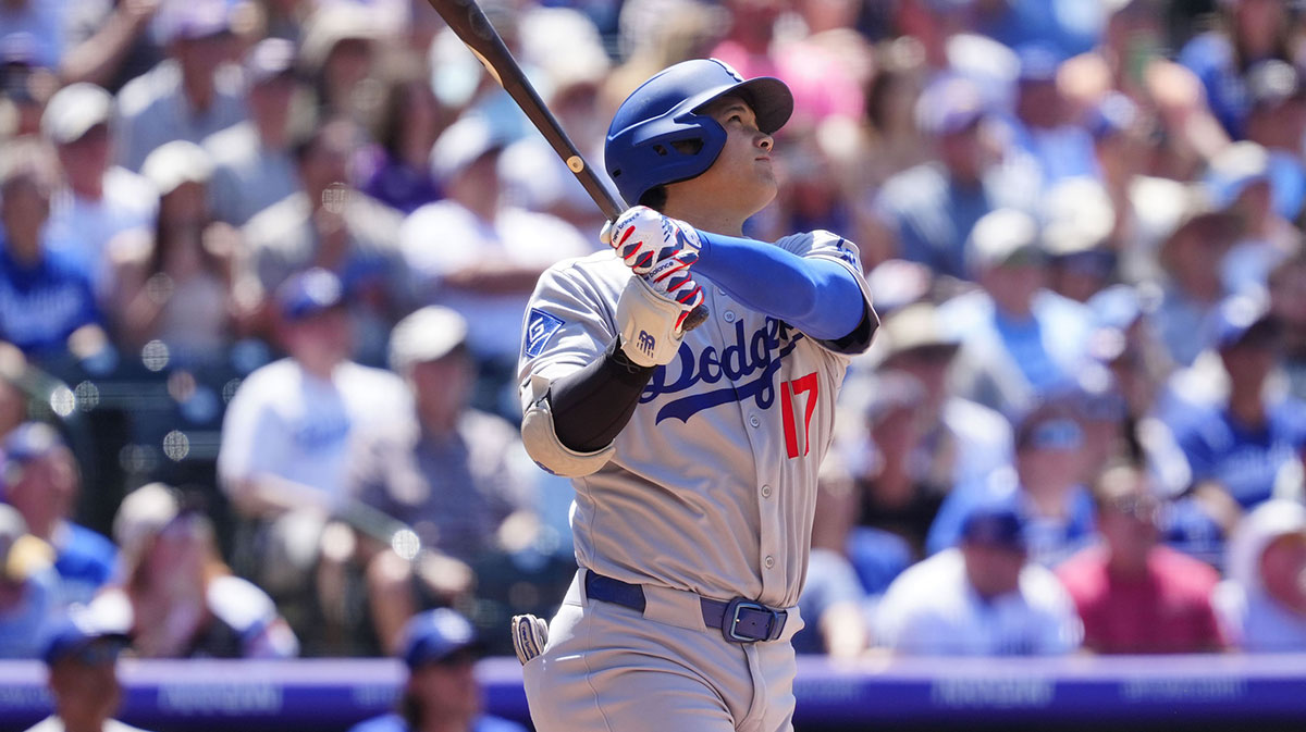 Los Angeles Dodgers designated hitter Shohei Ohtani (17) hits a solo home run in the seventh inning at Coors Field.