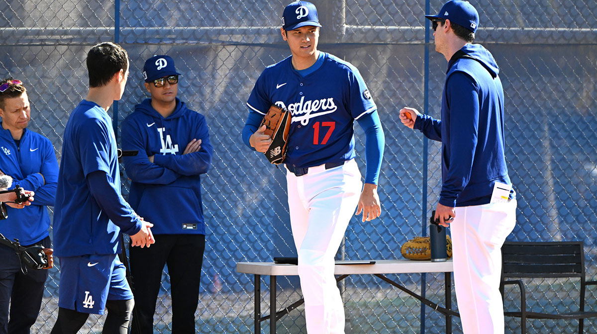 Los Angeles Dodgers designated hitter Shohei Ohtani (17) works with Los Angeles Dodgers assistant pitching coach Connor McGuiness (87) during a spring training bullpen session at Camelback Ranch.