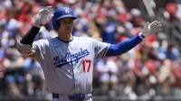 Los Angeles Dodgers designated hitter Shohei Ohtani (17) reacts after hitting a double against the St. Louis Cardinals during the first inning at Busch Stadium.