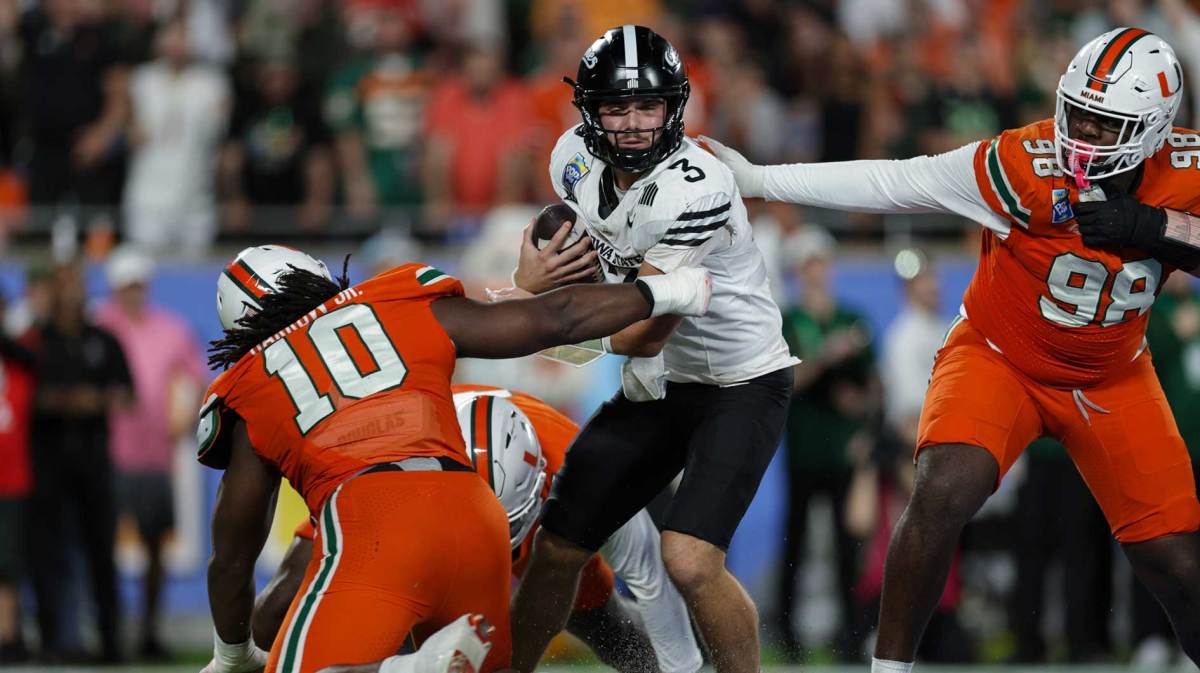 Iowa State Cyclones quarterback Rocco Becht (3) is pressured by Miami Hurricanes defensive lineman Simeon Barrow Jr. (10) in the fourth quarter during the Pop Tarts bowl at Camping World Stadium.