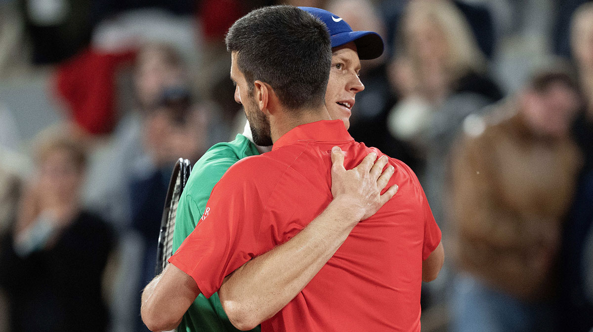 Jannik Sinner of Italy at the net with Novak Djokovic of Serbia after their match on day 13 at Roland Garros Stadium.