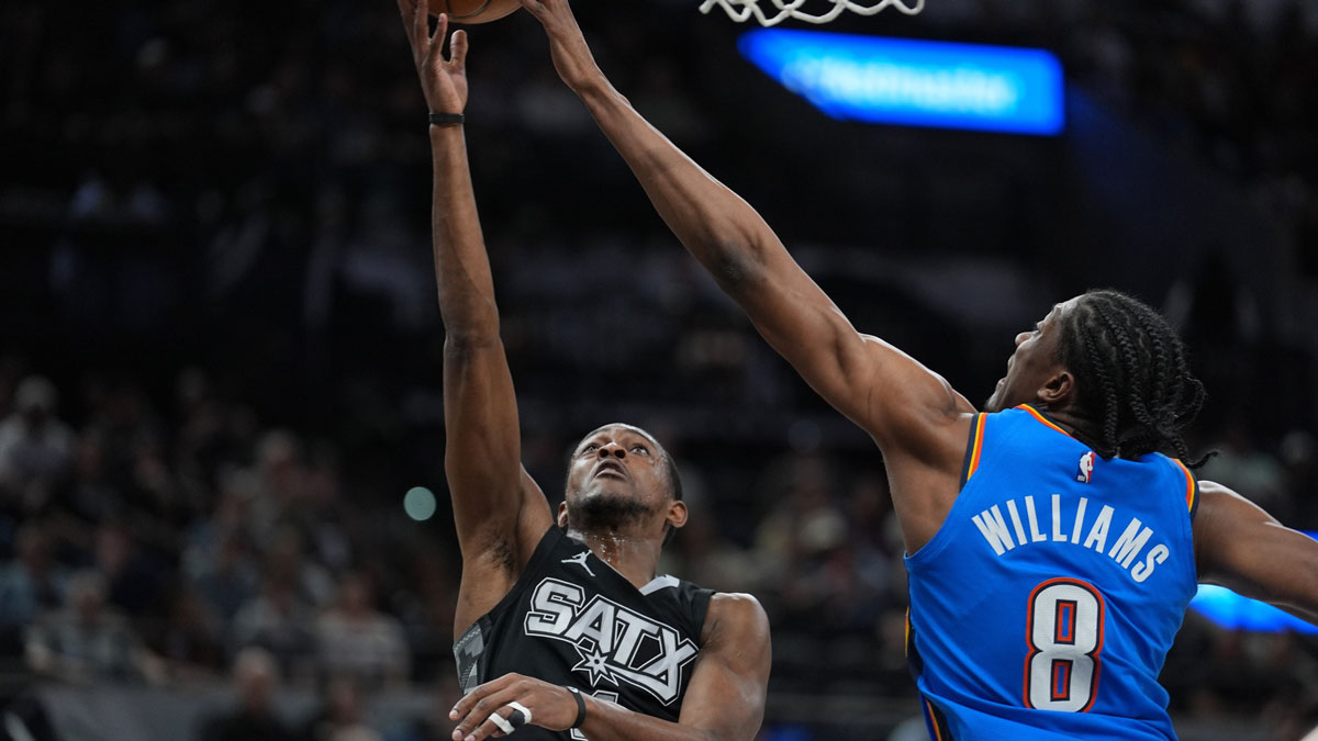 Oklahoma City Thunder forward Jalen Williams (8) blocks a shot by San Antonio Spurs guard De'Aaron Fox (4) in the first half at Frost Bank Center.