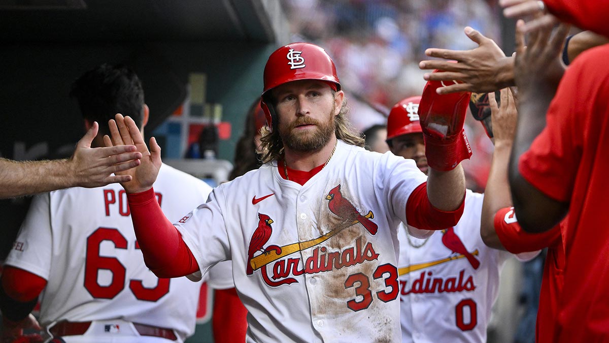 St. Louis Cardinals second baseman Brendan Donovan (33) is congratulated by teammates after scoring against the Kansas City Royals during the third inning at Busch Stadium.