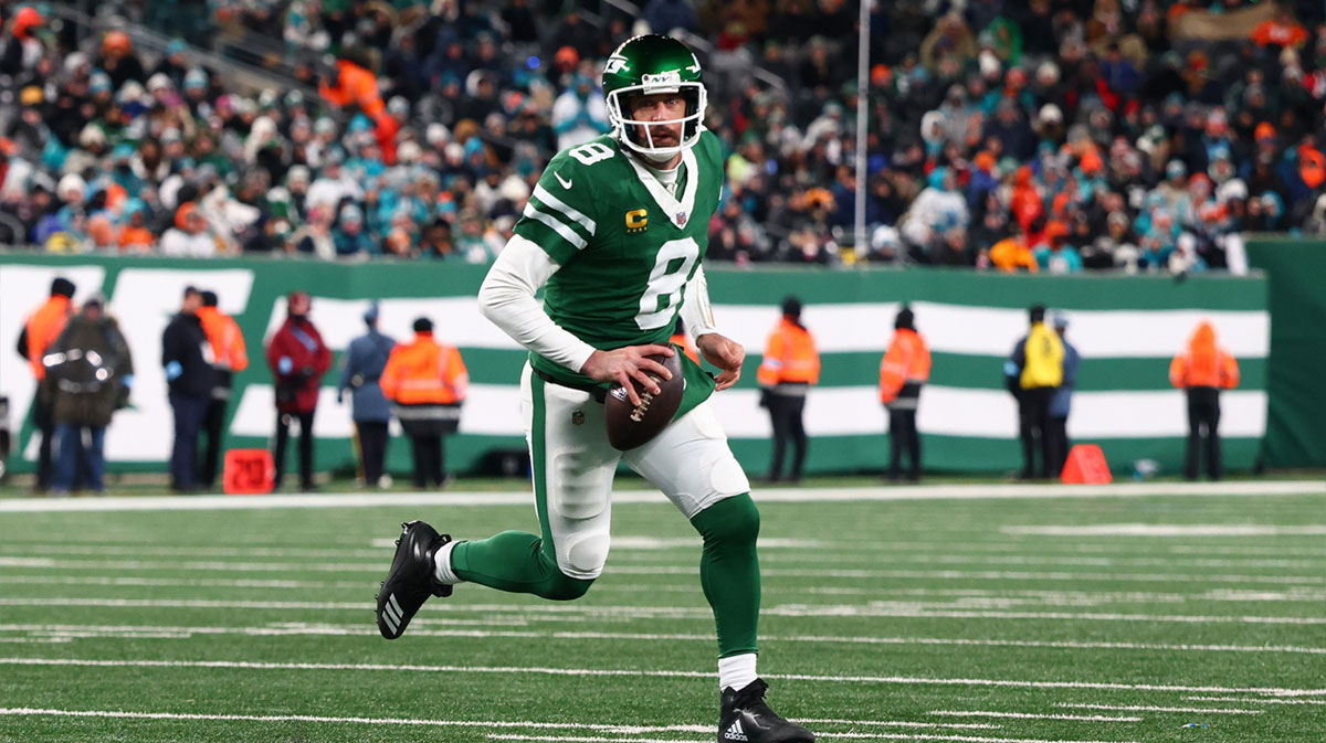 New York Jets quarterback Aaron Rodgers (8) runs with the ball during the third quarter of their game against the Miami Dolphins at MetLife Stadium.
