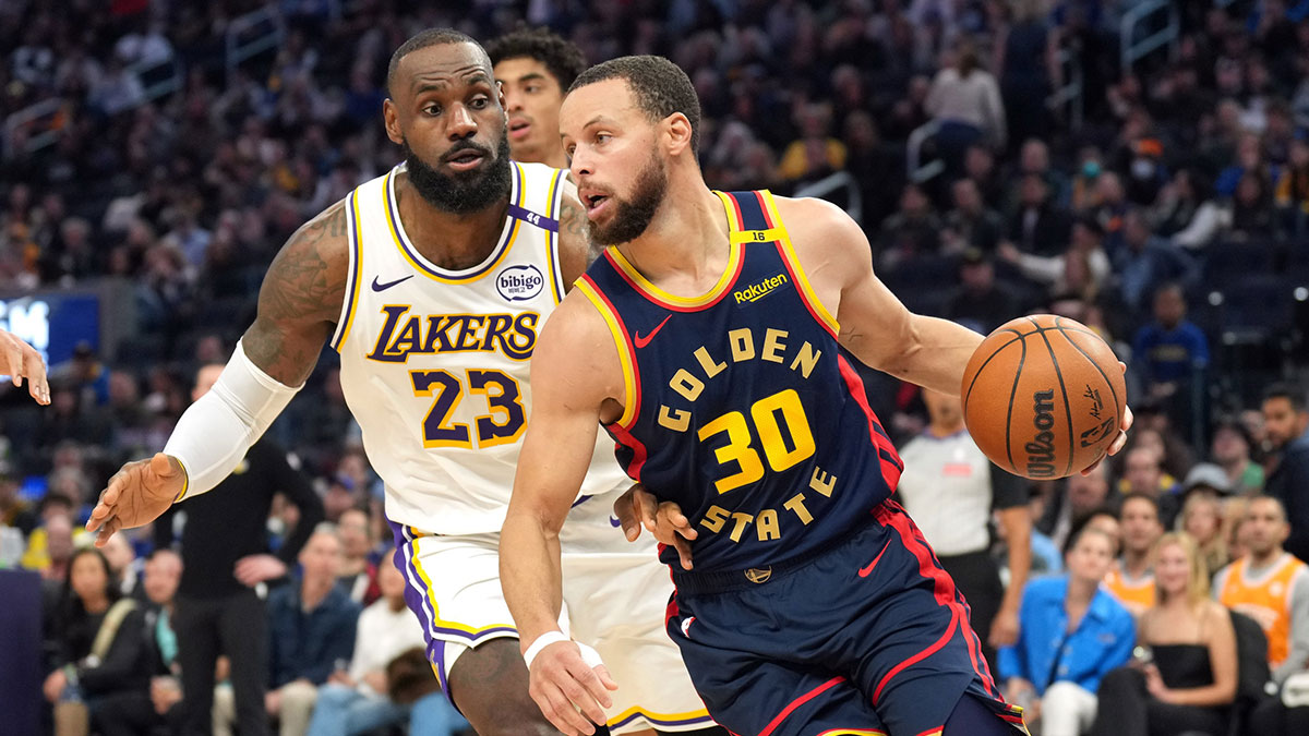 Golden State Warriors guard Stephen Curry (30) dribbles against Los Angeles Lakers forward LeBron James (23) during the third quarter at Chase Center.