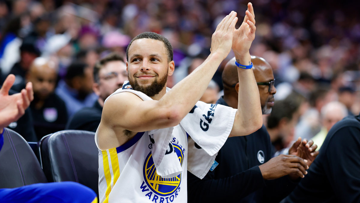 Golden State Warriors guard Stephen Curry (30) claps from the bench during the fourth quarter against the Sacramento Kings at Golden 1 Center.