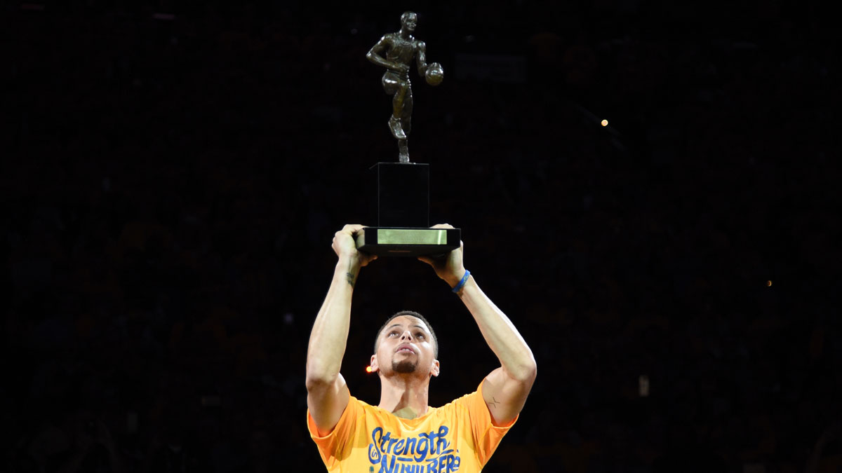 Golden State Warriors guard Stephen Curry (30) hoists the MVP trophy before game five of the second round of the NBA Playoffs against the Portland Trail Blazers at Oracle Arena.