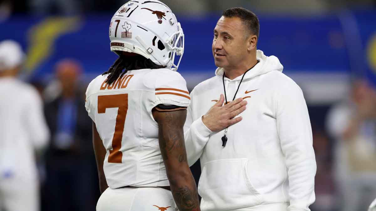 Texas Longhorns head coach Steve Sarkisian talks to wide receiver Isaiah Bond (7) before the College Football Playoff semifinal against the Ohio State Buckeyes in the Cotton Bowl at AT&T Stadium.