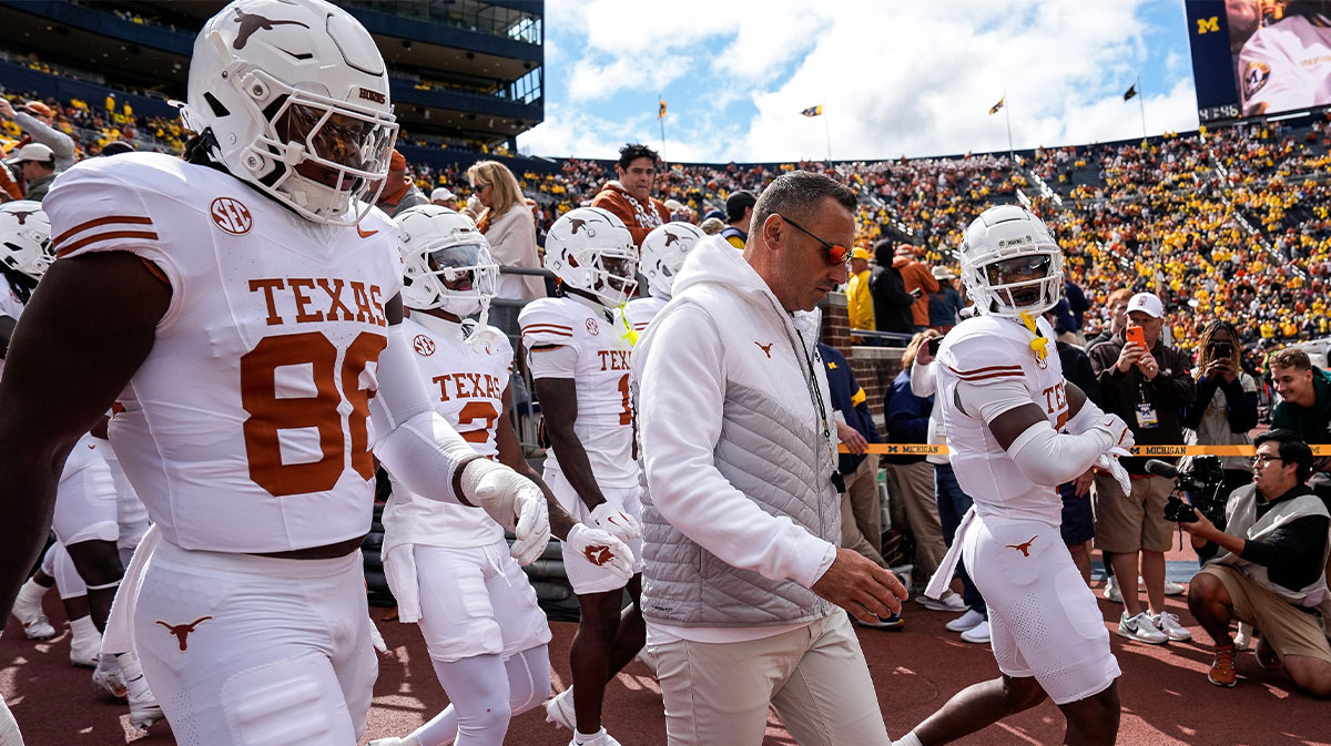 Texas head coach Steve Sarkisian and the Texas players take the field for warm up at Michigan Stadium in Ann Arbor on Saturday, September 7, 2024.