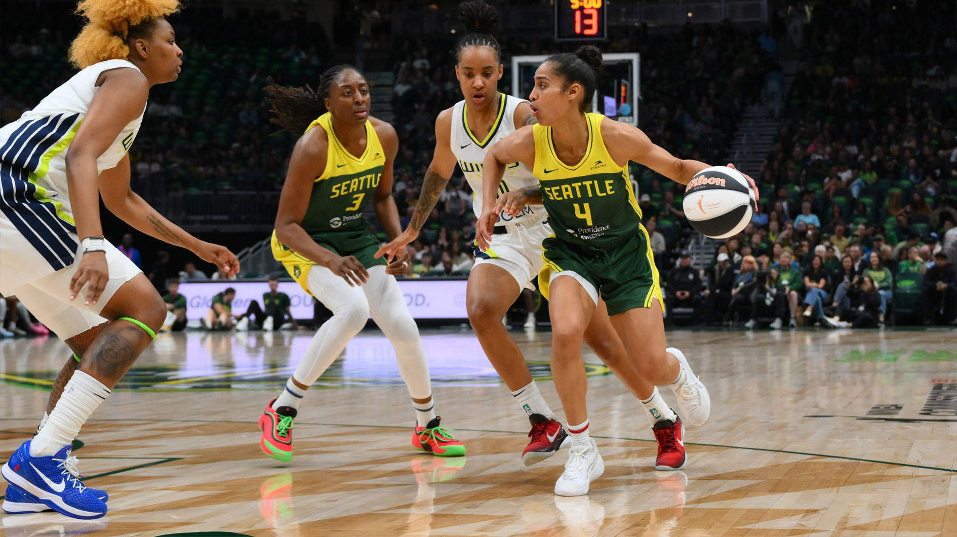 Seattle Storm guard Skylar Diggins (4) dribbles the ball while defended by Dallas Wings guard Aziaha James (10) during the first half at Climate Pledge Arena.