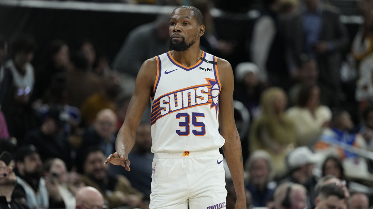 Suns forward Kevin Durant (35) enters the game during the first half against the San Antonio Spurs at Moody Center with Bill Simmons in the background