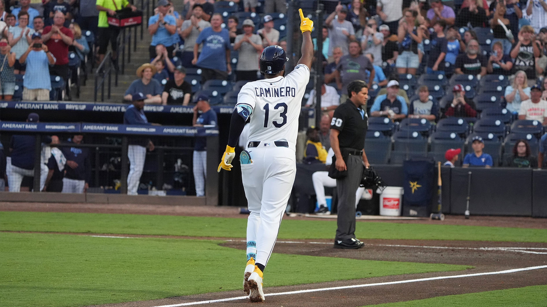 Tampa Bay Rays third base Junior Caminero (13) points to the crowd as he runs the bases after hitting a home run against the Texas Rangers during the second inning at George M. Steinbrenner Field.
