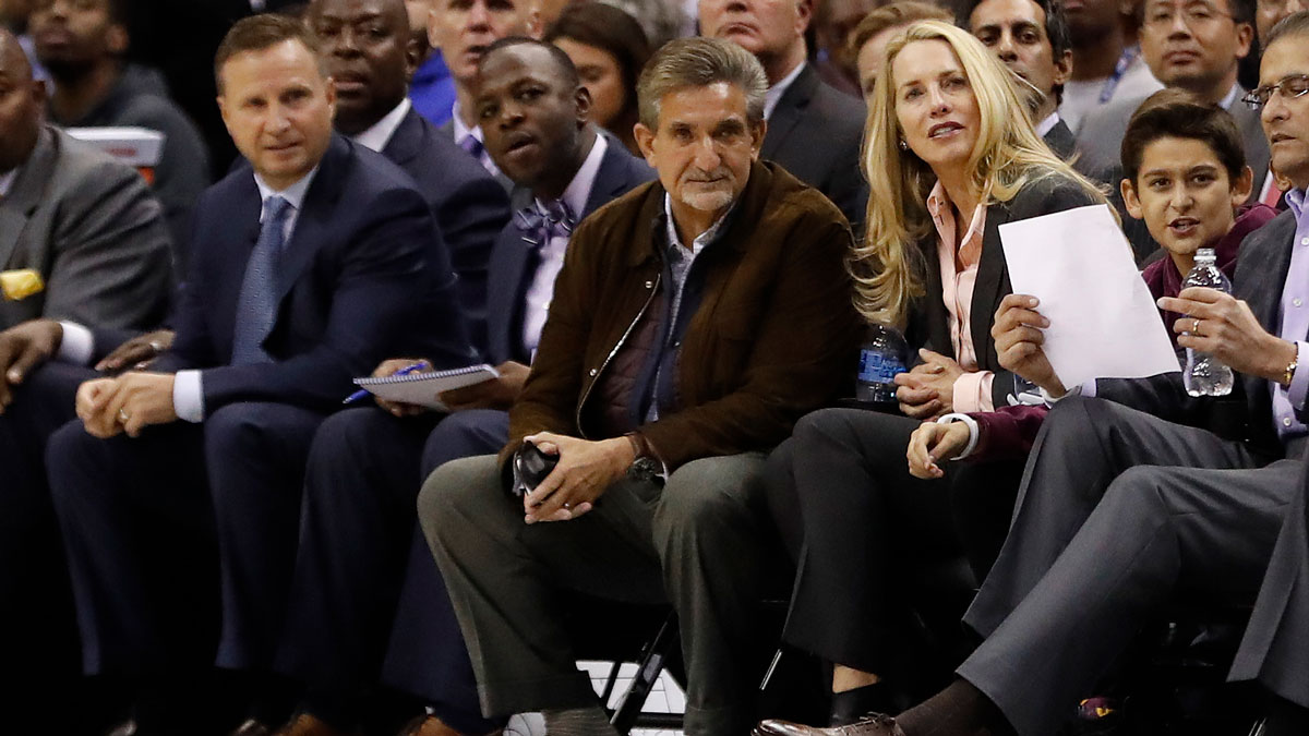 Washington Wizards owner Ted Leonsis (M) sits courtside with new minority owner Laurene Powell (R) during the second quarter of the Wizards' game against the Philadelphia 76ers at Capital One Arena. The Wizards won 120-115.