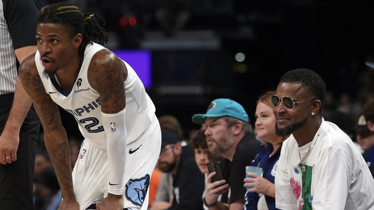 Memphis Grizzlies guard Ja Morant (12) waits for play to resume in front of his father, Tee Morant during the second half against the Brooklyn Nets at FedExForum.