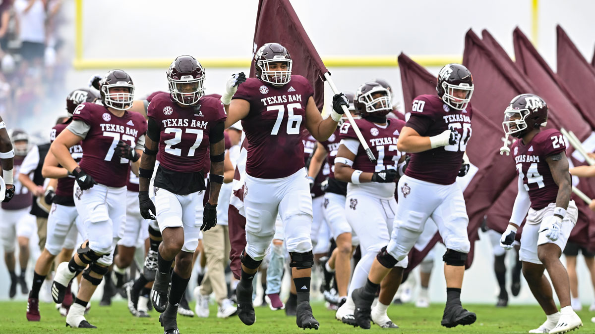 Texas A&M Aggies offensive lineman Reuben Fatheree II (76) carries the flag as he runs out prior to the game against the Sam Houston State Bearkats at Kyle Field.