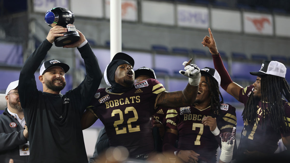 Texas State Bobcats head coach GJ Kinne celebrates with the trophy after the game against the North Texas Mean Green at Gerald J. Ford Stadium.