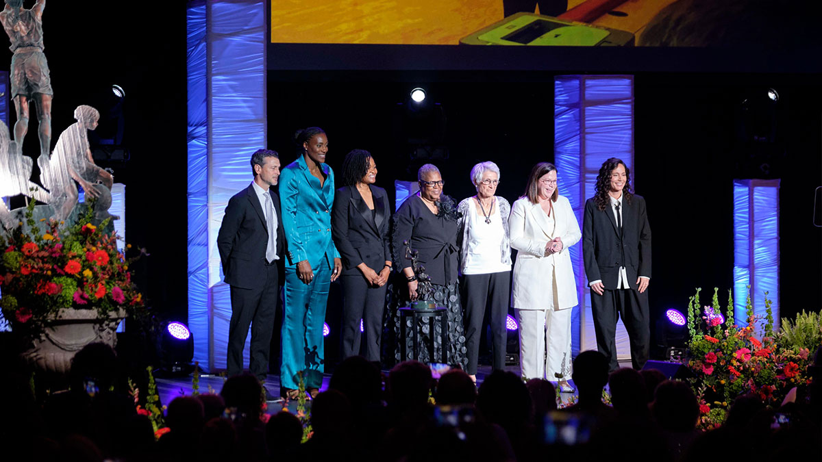 The 2025 Women’s Basketball Hall of Fame Inductees, from left, Mark Campbell, Sylva Fowles, Alana Beard, Lucille Kyvallos, Danielle Donehew, and Sue Bird receive applause during the 2025 WBHOF Induction Ceremony.