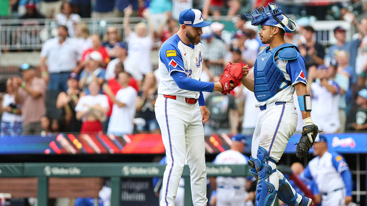 Atlanta Braves pitcher Dylan Lee (52) and Atlanta Braves catcher Drake Baldwin (30) shake hands after a victory against the Colorado Rockies at Truist Park.