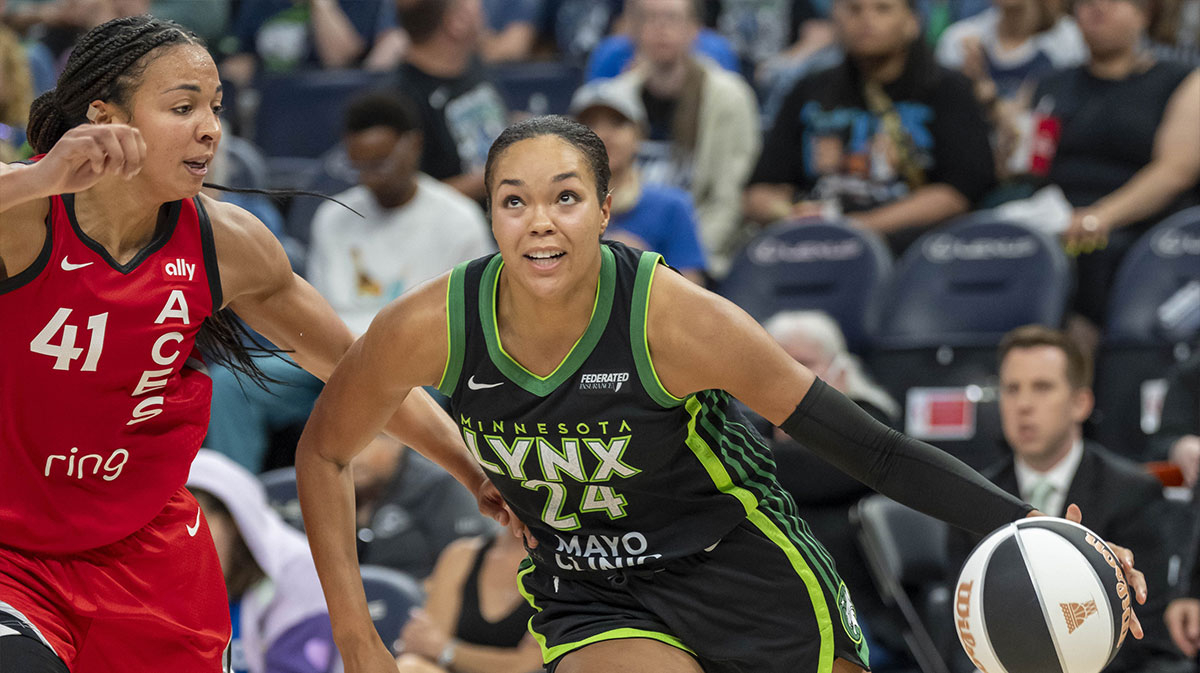 Minnesota Lynx forward Napheesa Collier (24) dribbles the ball past Las Vegas Aces center Kiah Stokes (41) in the second half at Target Center.