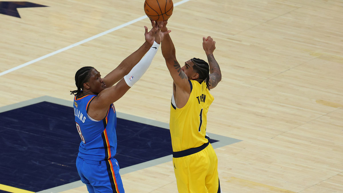 Thunder forward Jalen Williams (8) shoots a three point basket over Indiana Pacers forward Obi Toppin (1) during the third quarter of game four of the 2025 NBA Finals at Gainbridge Fieldhouse