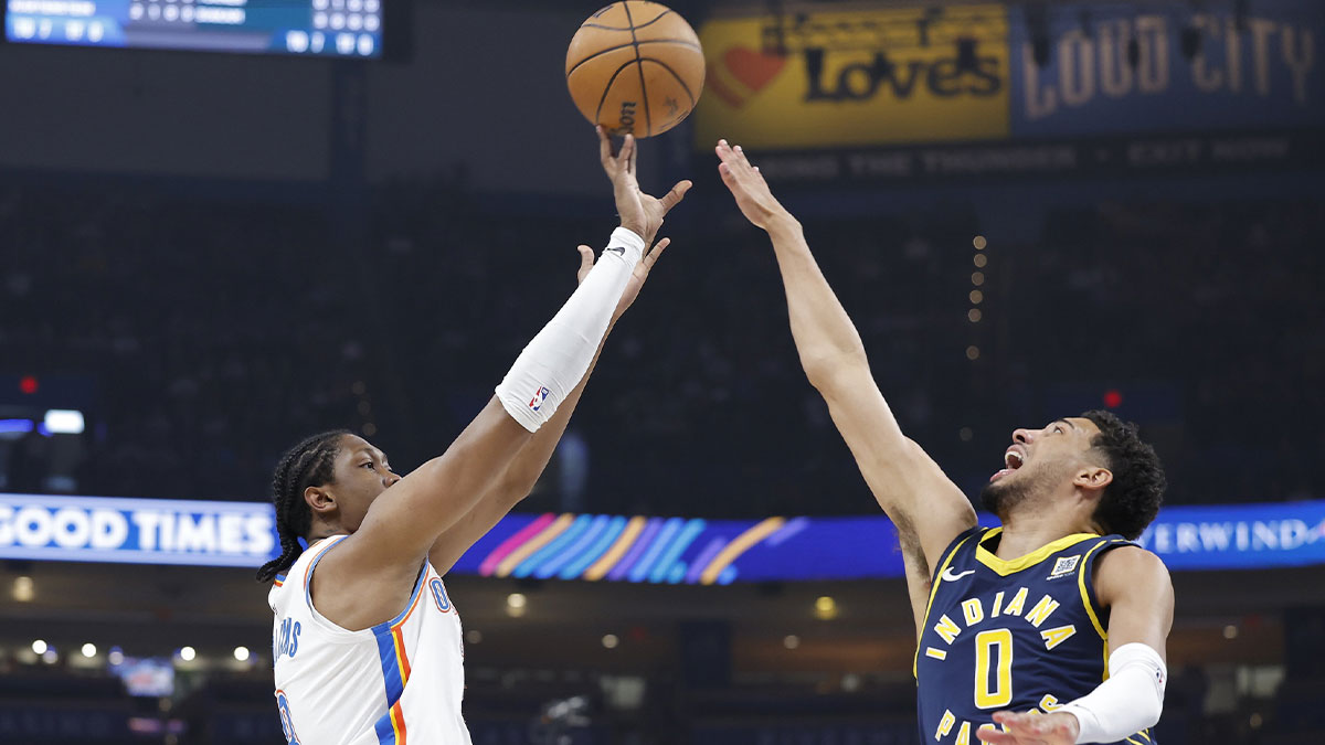 Thunder forward Jalen Williams (8) shoots a three point basket as Indiana Pacers guard Tyrese Haliburton (0) defends during the first quarter at Paycom Center