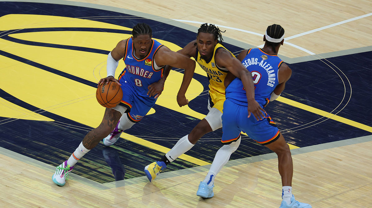 Thunder forward Jalen Williams (8) drives to the hoop as Oklahoma City Thunder guard Shai Gilgeous-Alexander (2) blocks Indiana Pacers forward Aaron Nesmith (23) during the fourth quarter of game four of the 2025 NBA Finals at Gainbridge Fieldhouse
